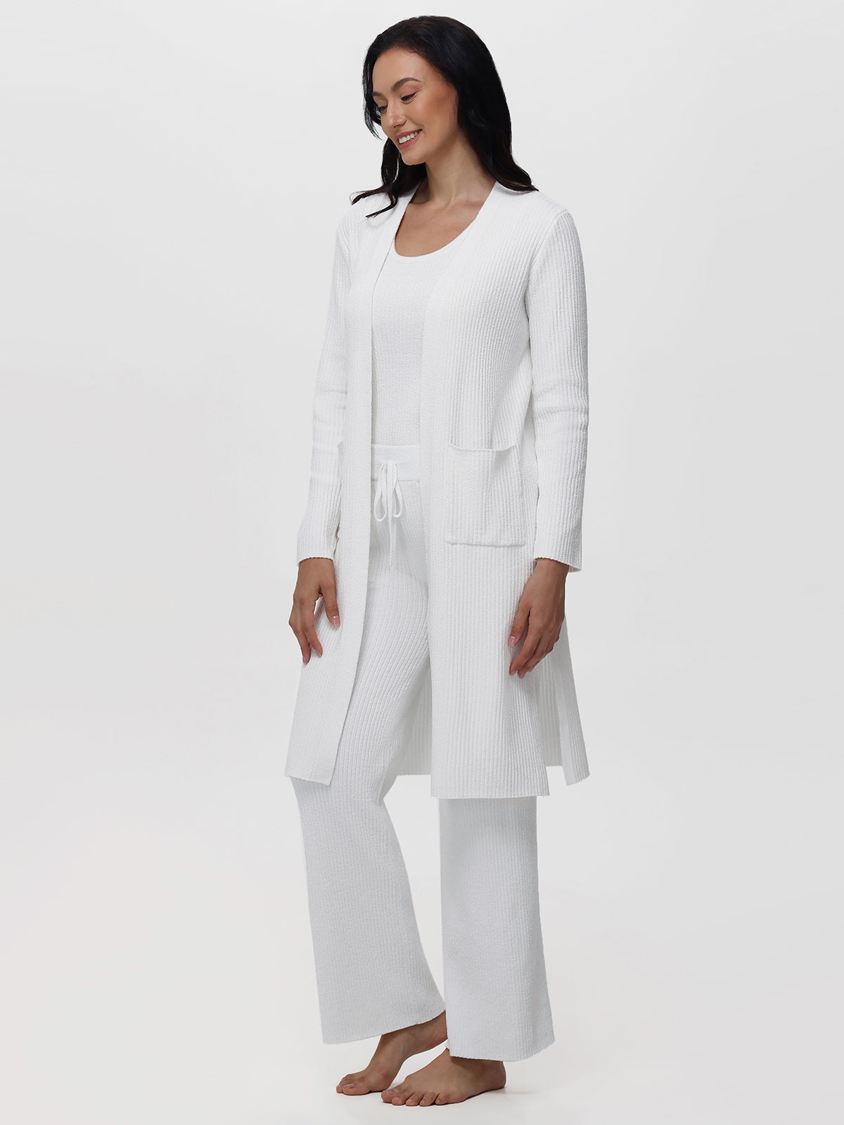 Woman wearing a white outfit on a plain background