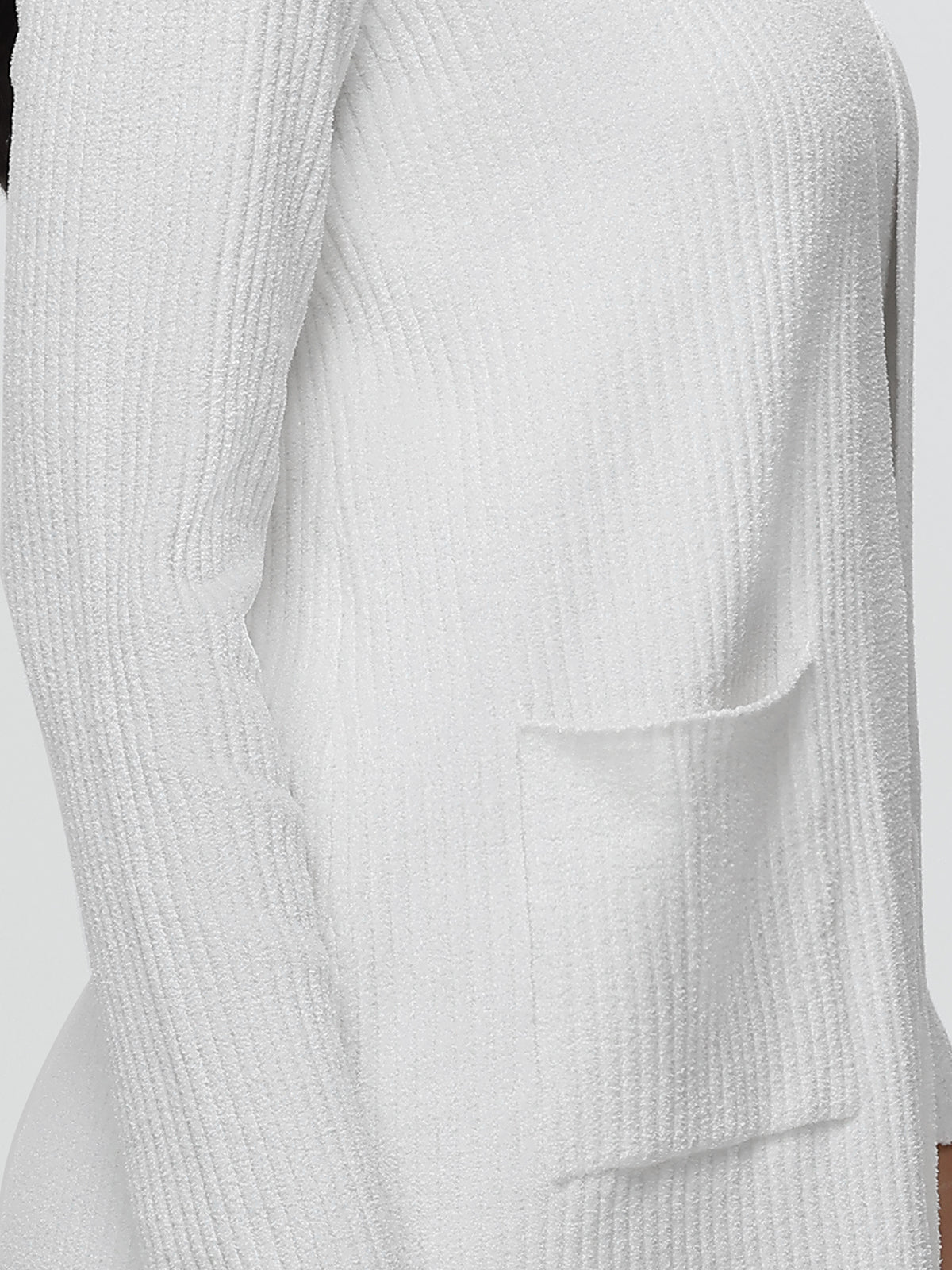 Close-up of a textured white sweater with a pocket on a light gray background