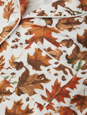 Fall-themed fabric with leaves and acorns on a white background