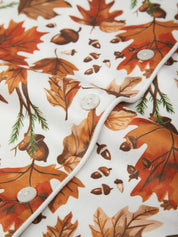 Close-up of a shirt with autumn leaf and acorn pattern on a white background