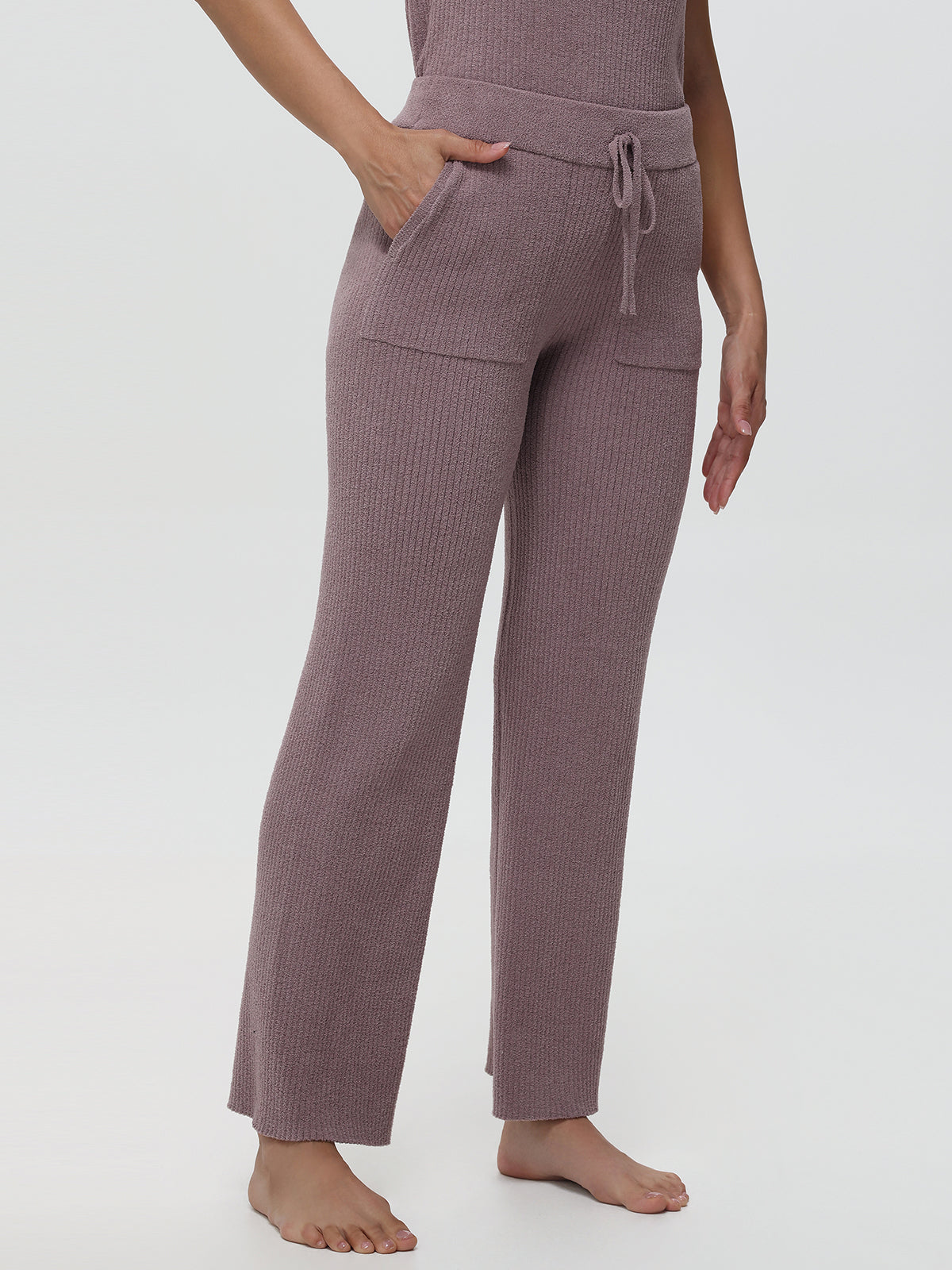 Woven pants worn by a person on a white background