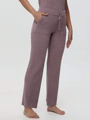 Woven pants worn by a person on a white background