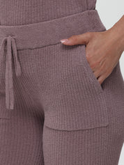 Close-up of a person wearing a ribbed knit outfit with a drawstring waist.