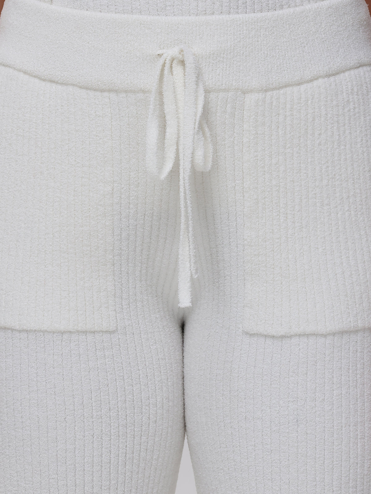 Close-up of white textured pants with a drawstring.