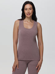 Woman wearing a bark ribbed tank top and pants on a light gray background