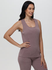 Woman wearing a mauve sleeveless top and pants on a white background