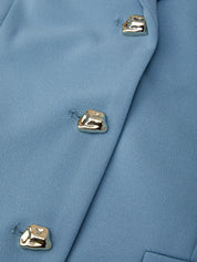 Close-up of a blue coat with gold buttons on a matching background