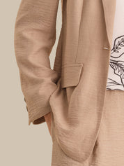 Close-up of a beige blazer with a neutral background
