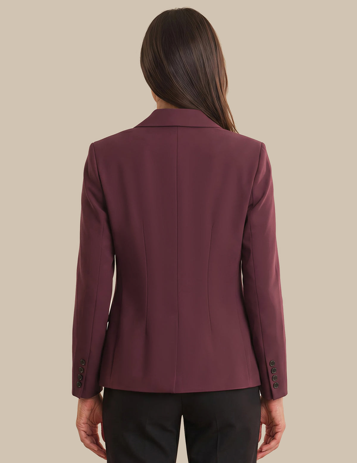 Maroon blazer worn by a person on a beige background