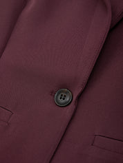 Close-up of a burgundy jacket with a button