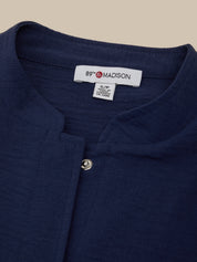 Navy blue shirt with a visible brand label on a beige background