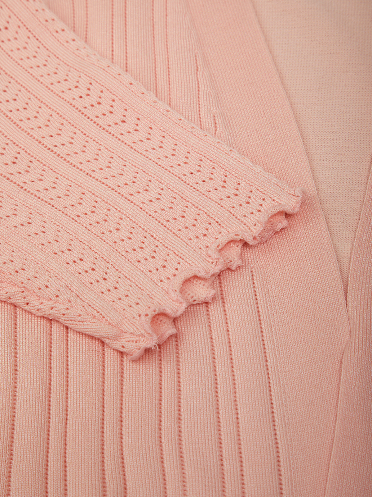 Close-up of a pink textured fabric with a subtle pattern