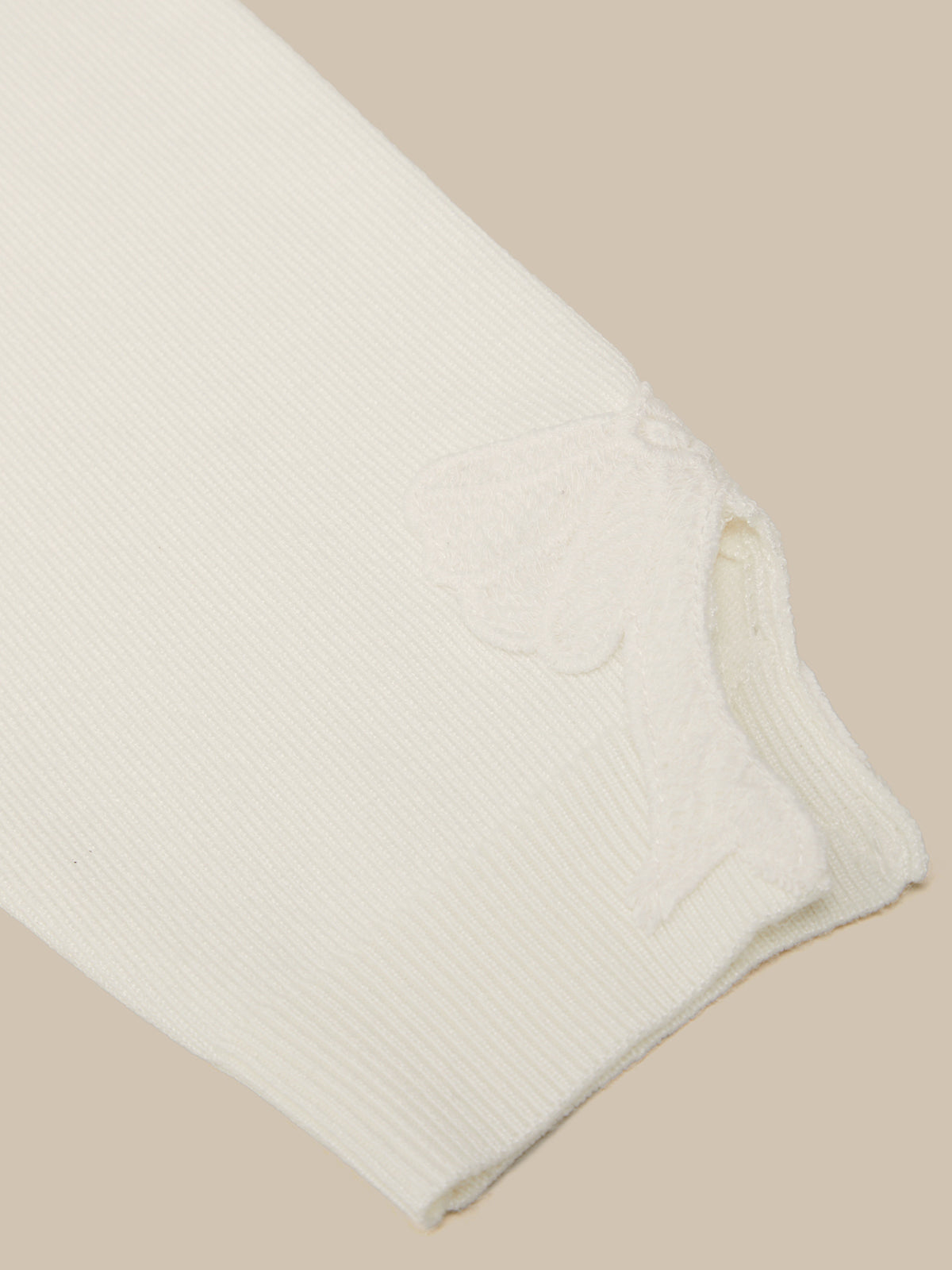 Folded white fabric on a beige background