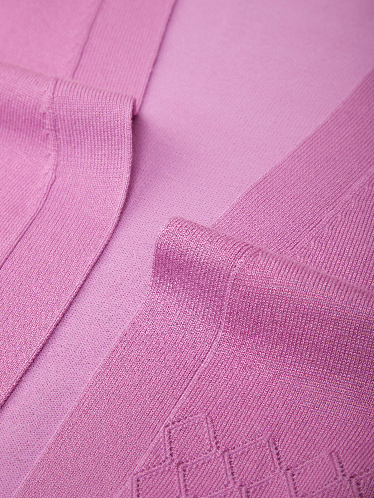 Close-up of a pink textured fabric with geometric patterns