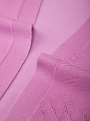 Close-up of a pink textured fabric with geometric patterns