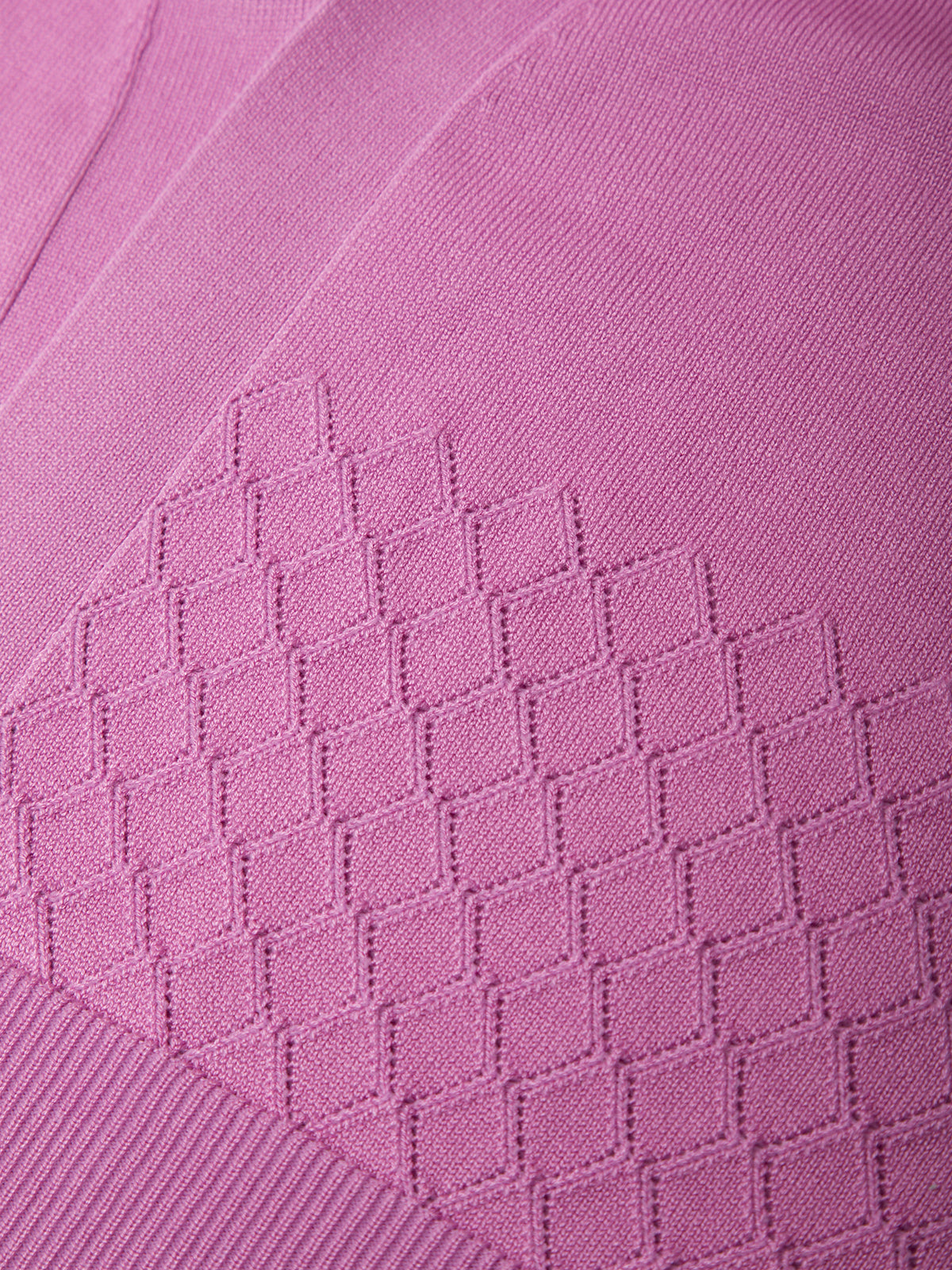 Close-up of a pink fabric with a diamond pattern