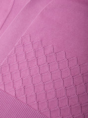 Close-up of a pink fabric with a diamond pattern