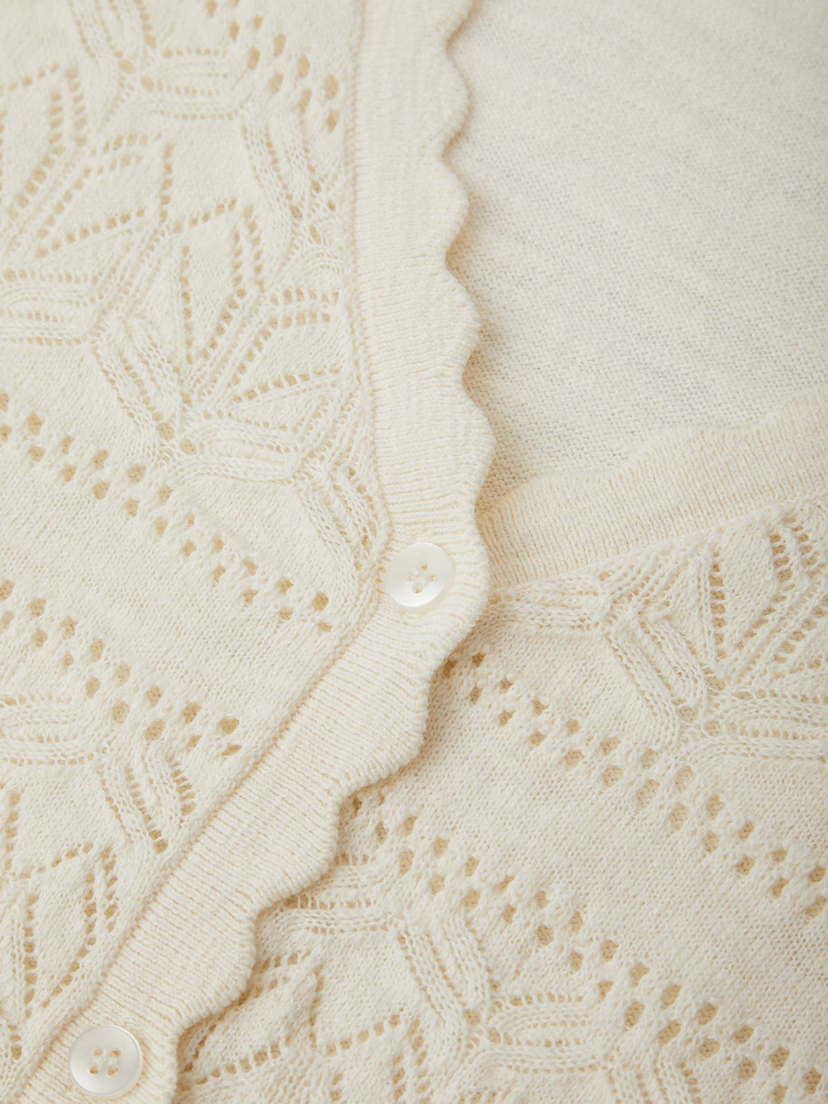 Close-up of a textured beige fabric with a subtle pattern