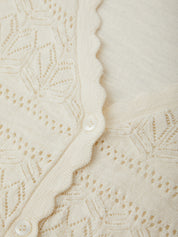 Close-up of a textured beige fabric with a subtle pattern