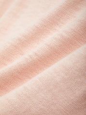 Close-up of pink fabric with a subtle pattern