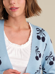 Light blue cardigan with black cherry pattern worn by a person
