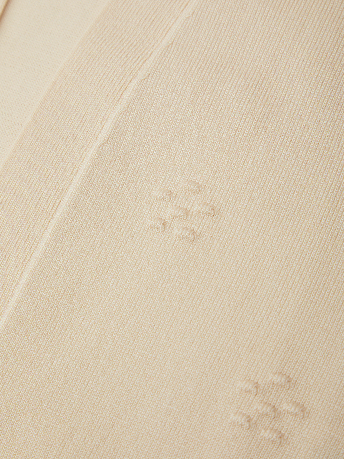 Close-up of beige fabric with visible stains