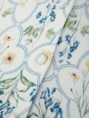 Close-up of floral patterned fabric with a button