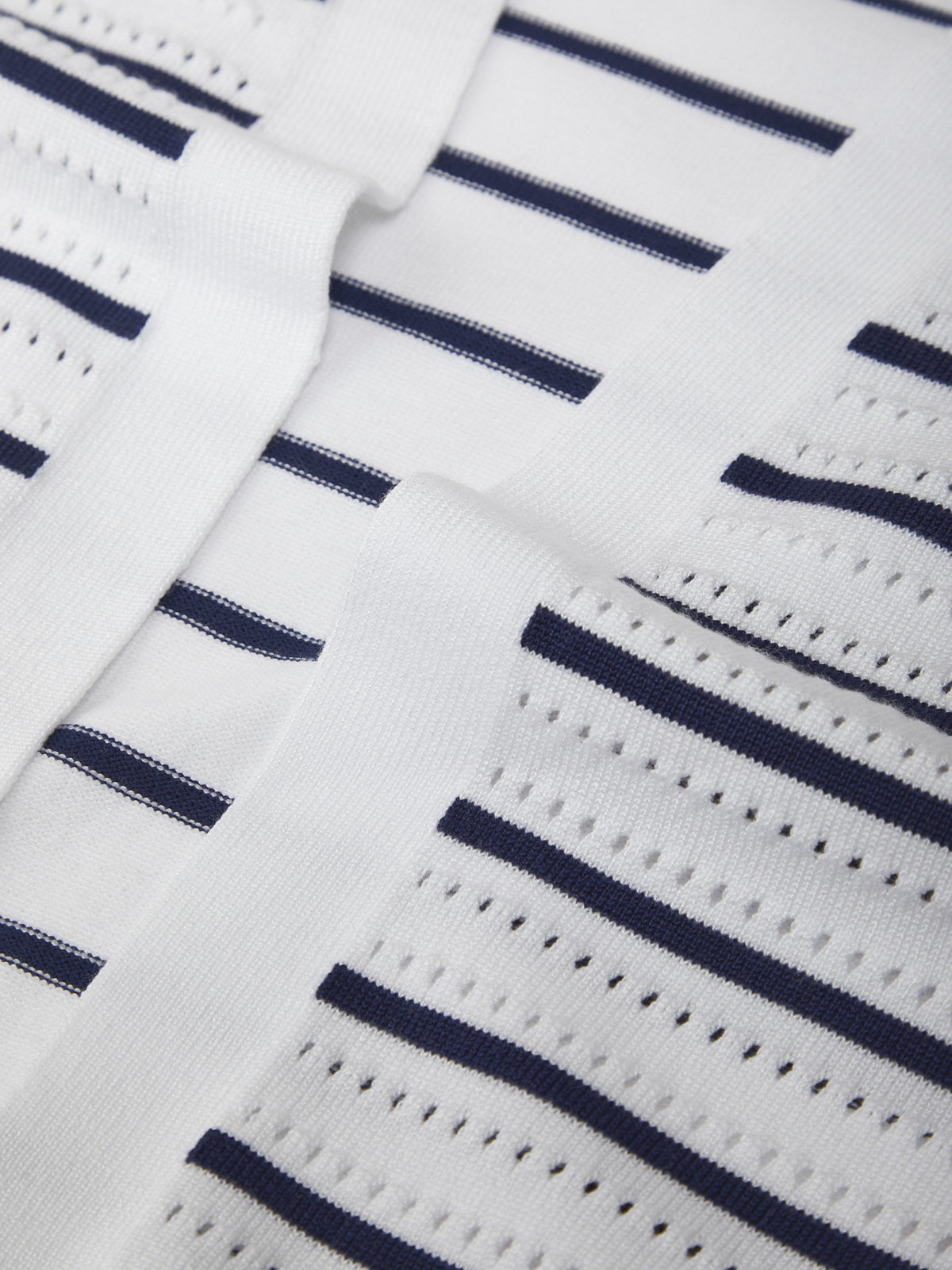 Close-up of a white fabric with navy blue stripes
