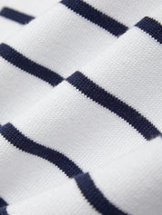 Close-up of white fabric with navy blue stripes