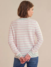 Woman wearing a striped sweater against a beige background