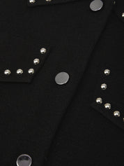 Close-up of a black jacket with silver studs and buttons.