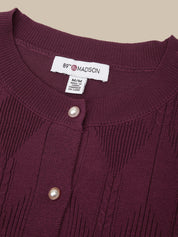 Close-up of a ribbed knit cardigan sweater in deep plum purple, featuring a white button-down collar label reading '89th MADISON' and two pearl-like buttons.