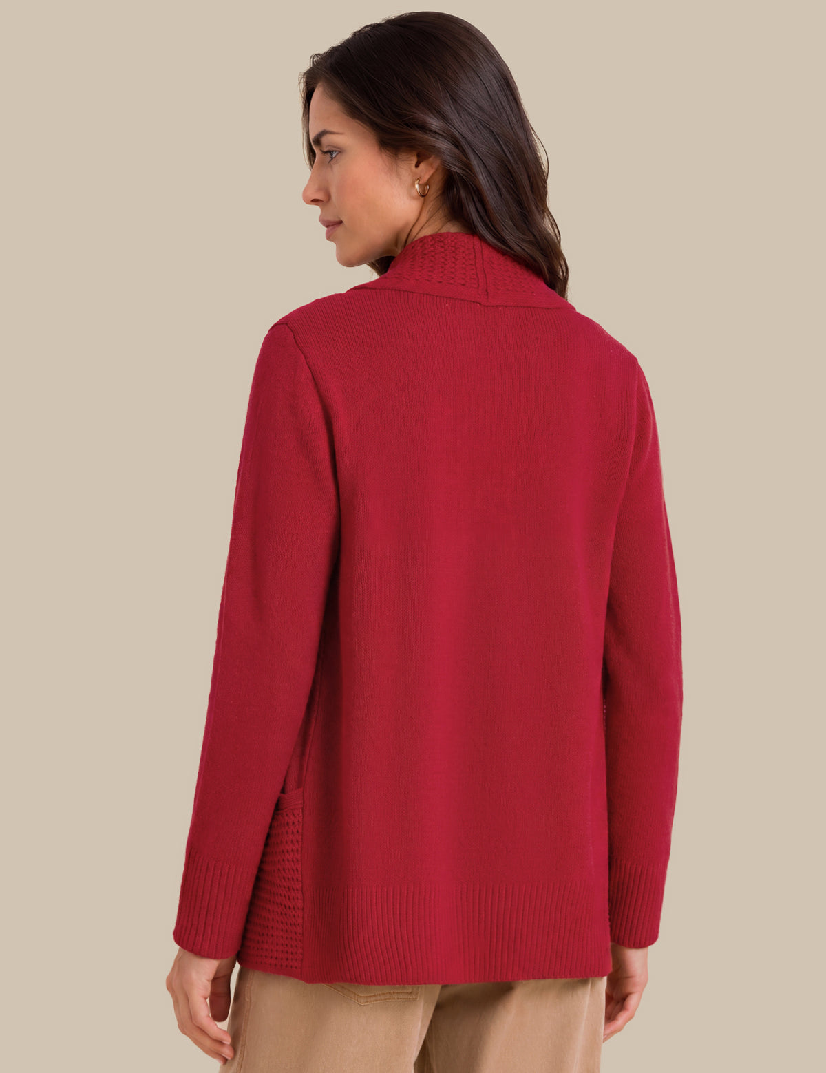 A woman shown from the back wearing a red knit sweater with a mock neck and ribbed cuffs, paired with beige pants, against a solid beige background.