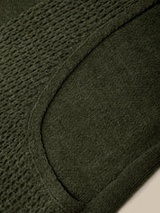 Close-up of a black coat with a brand label inside