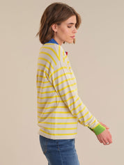 Woman wearing a striped sweater with a neutral background