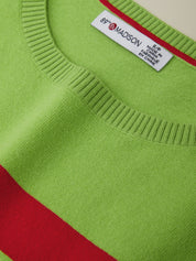 Close-up of a green sweater with a red stripe and a visible label.