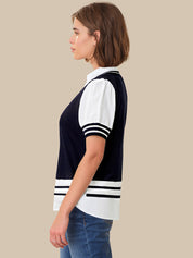 Woman wearing a navy and white striped shirt on a beige background