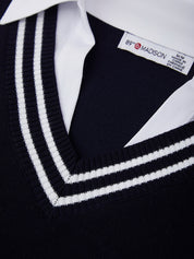 Close-up of a black sweater with white trim and a visible brand label.