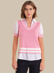 Woman wearing a pink and white striped sweater vest over a white shirt on a beige background