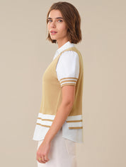 Woman wearing a beige and white striped shirt with a plain background