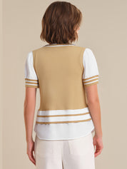 Woman wearing a beige and white striped sweater over a white shirt on a beige background