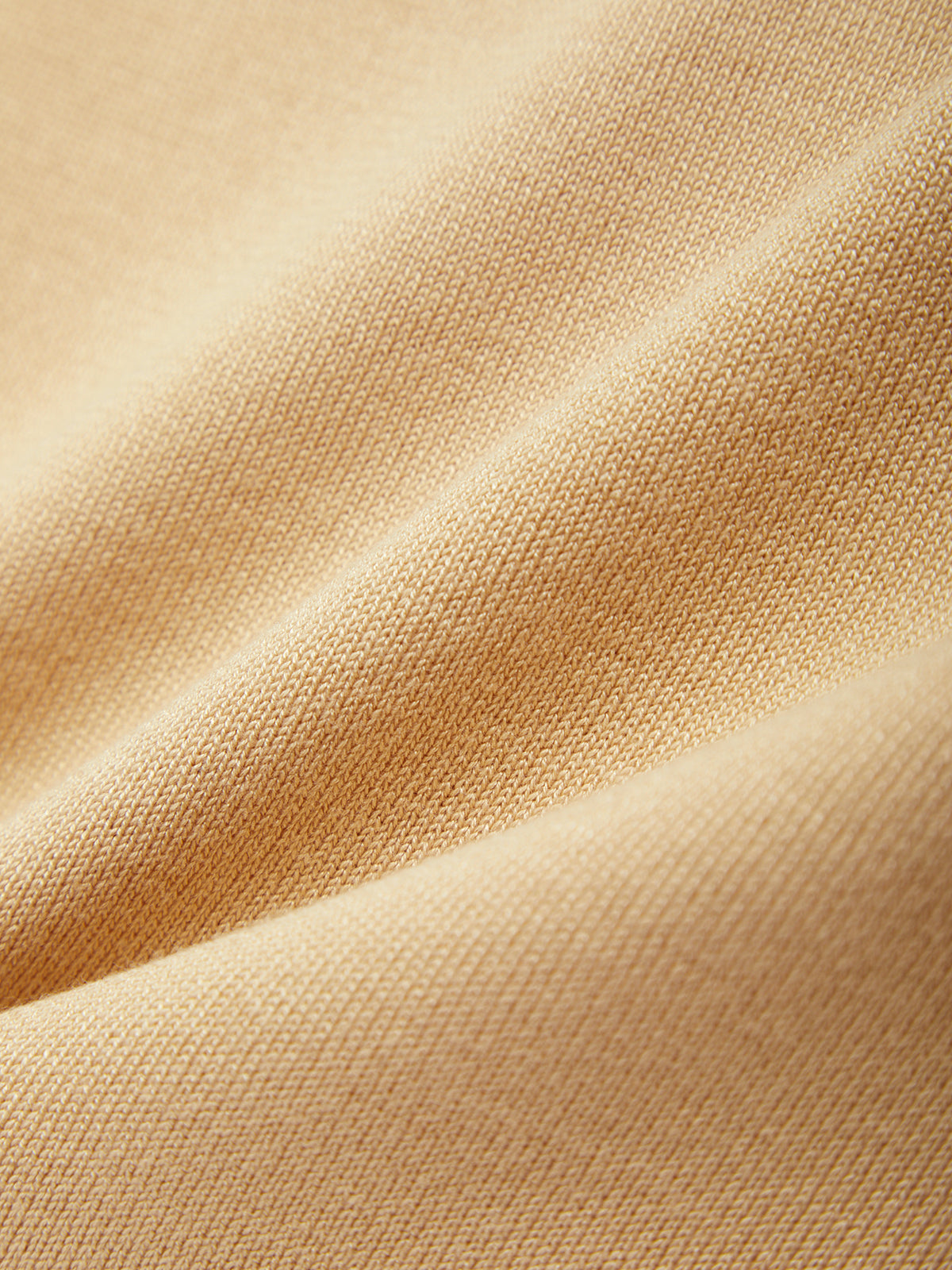 Close-up of beige fabric with subtle texture