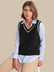 Woman wearing a black vest over a striped shirt on a beige background