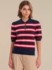 Woman wearing a striped sweater with a beige background