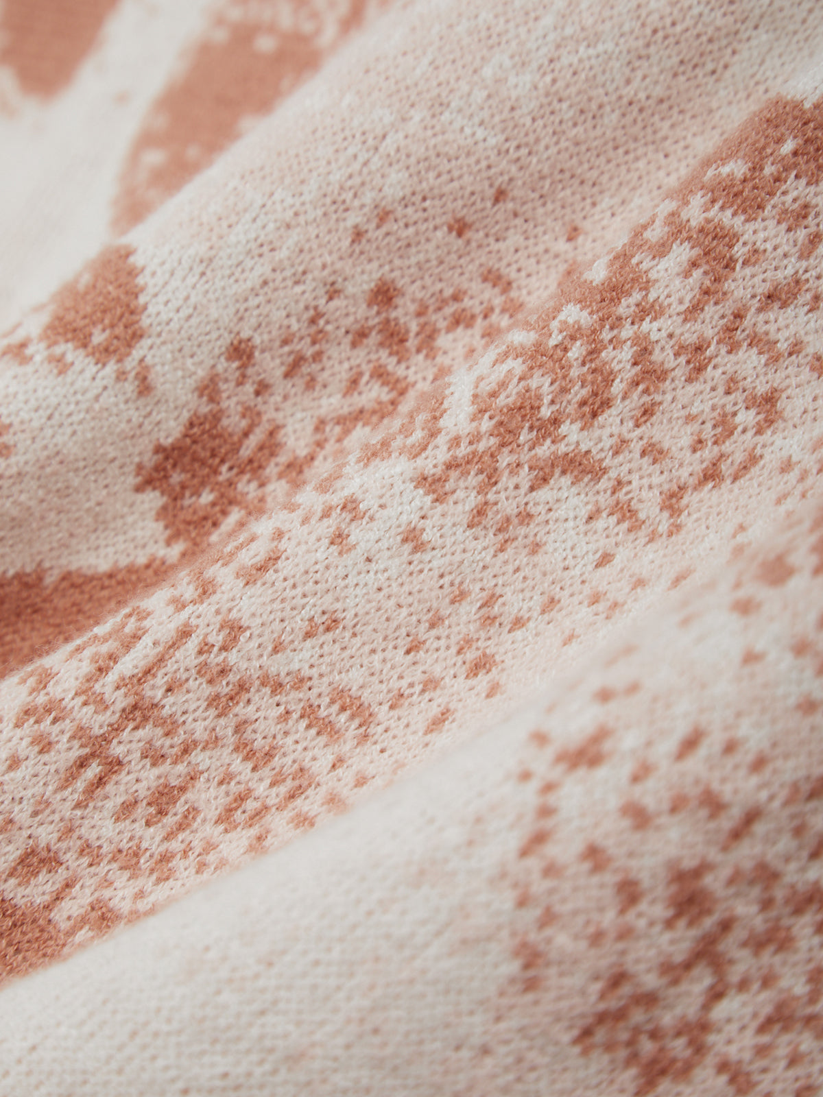 Close-up of a textured surface with pink and white colors