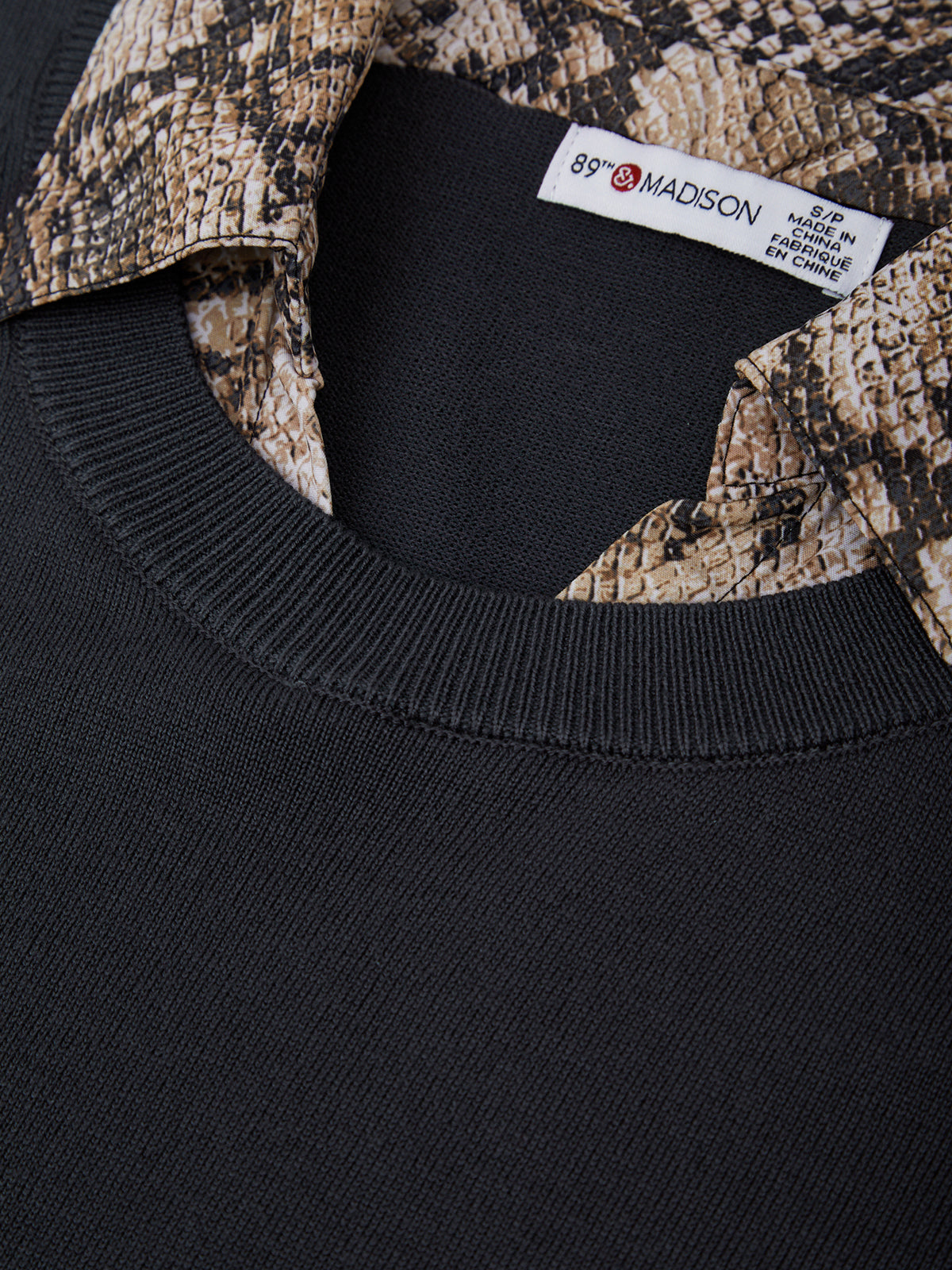 Black sweater with snake print collar and 89th Madison label.