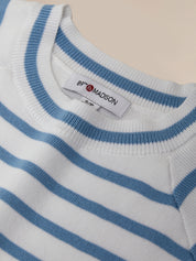Close-up of a blue and white striped sweater with a brand label.