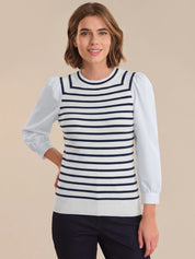 Woman wearing a striped sweater with a plain background