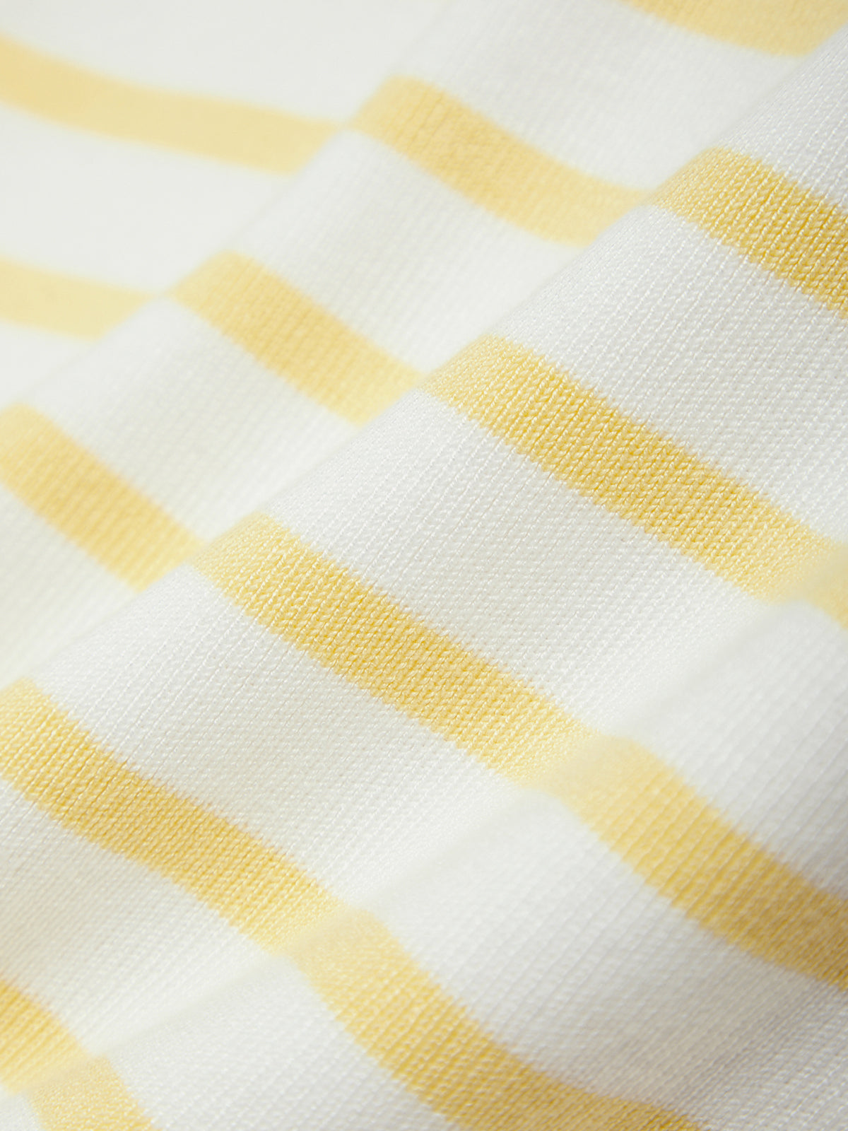 Close-up of yellow and white striped fabric texture