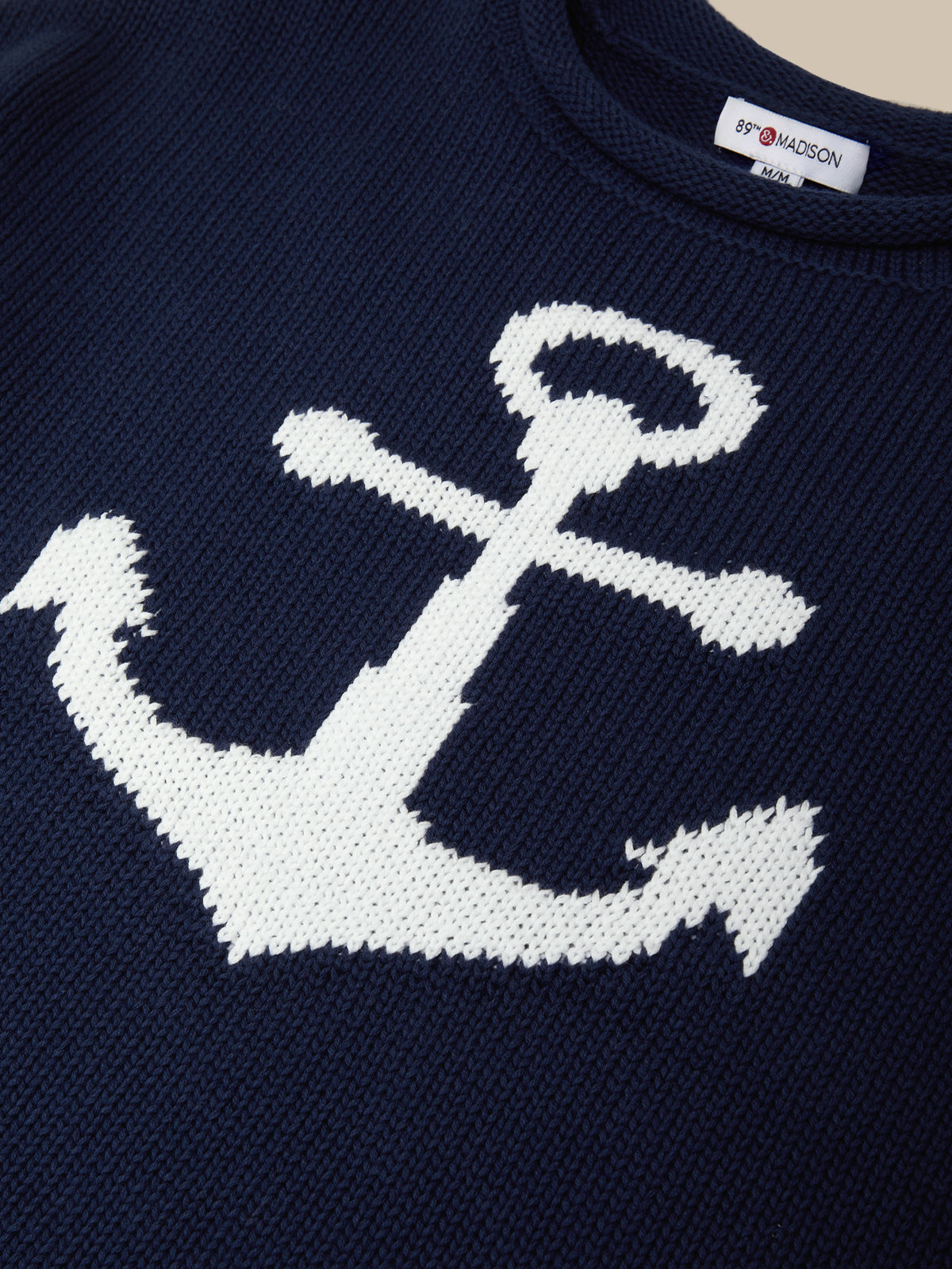 Navy sweater with a large white anchor design on a navy background